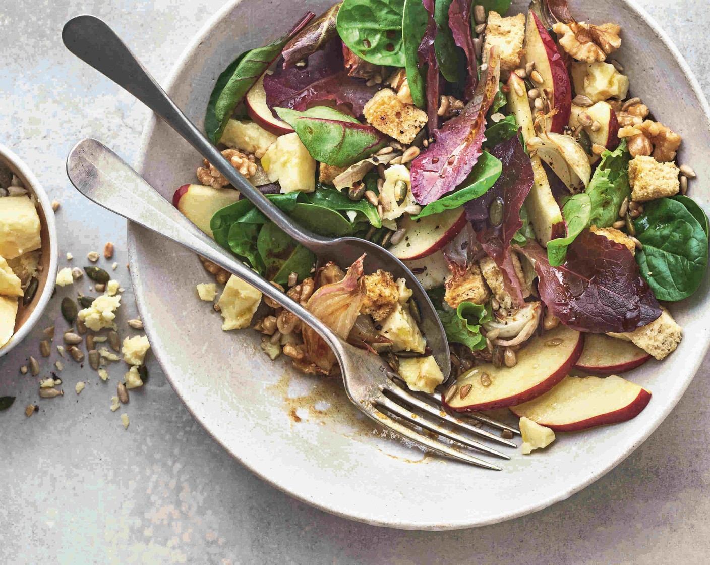step 3 When the shallots are cooked, leave them to cool for a few minutes, then mix them into the salad. Divide the salad between serving dishes, then scatter over the crumbled cheddar (160 g) and the seeds (40 g) and drizzle over the dressing.