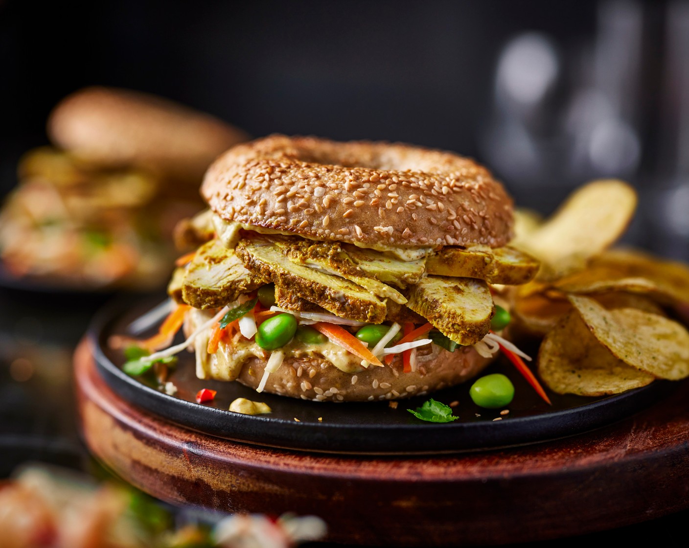 step 4 Load up the bagels with the katsu chicken, a crisps (100 g), and slaw. Serve alongside the roast chicken crisps.