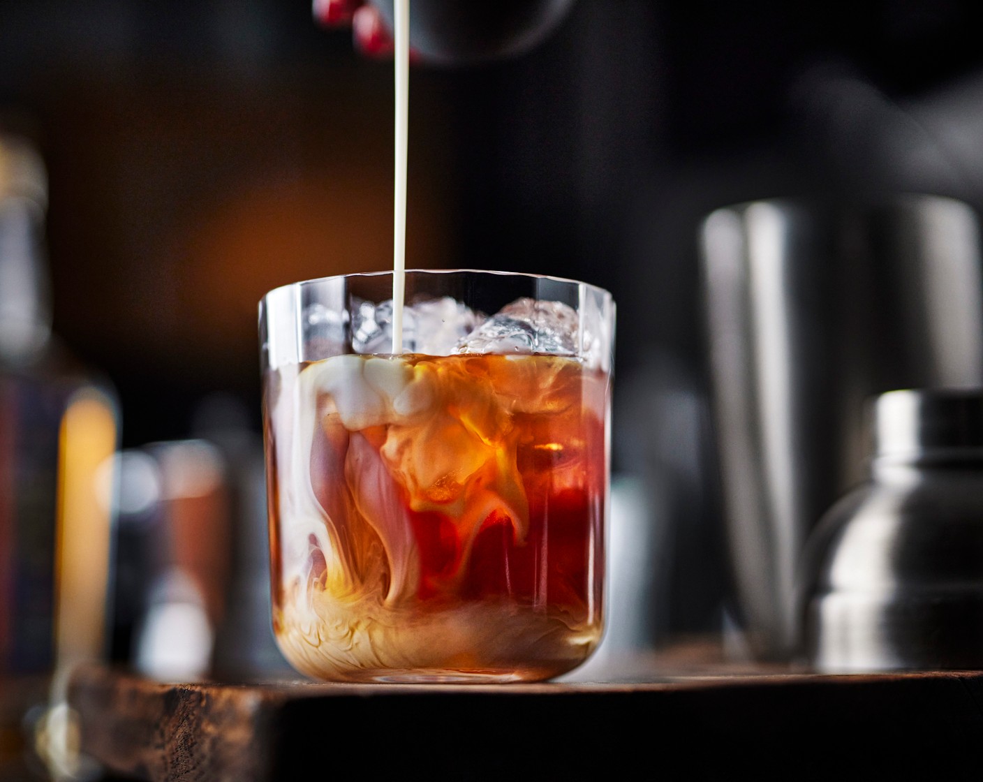 step 2 Place the remaining ice cubes (1 handful) into a tall glass. Pour over the coffee mix then top up with the oat drink (40 ml) and serve.