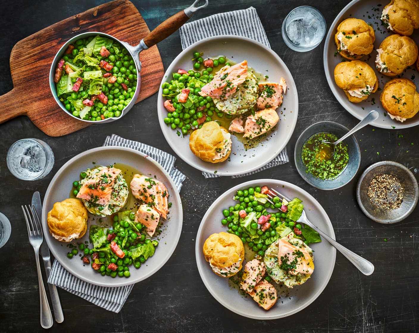 step 15 To serve, plate the salmon choux buns, peas and potatoes and pour the hollandaise over the fish.