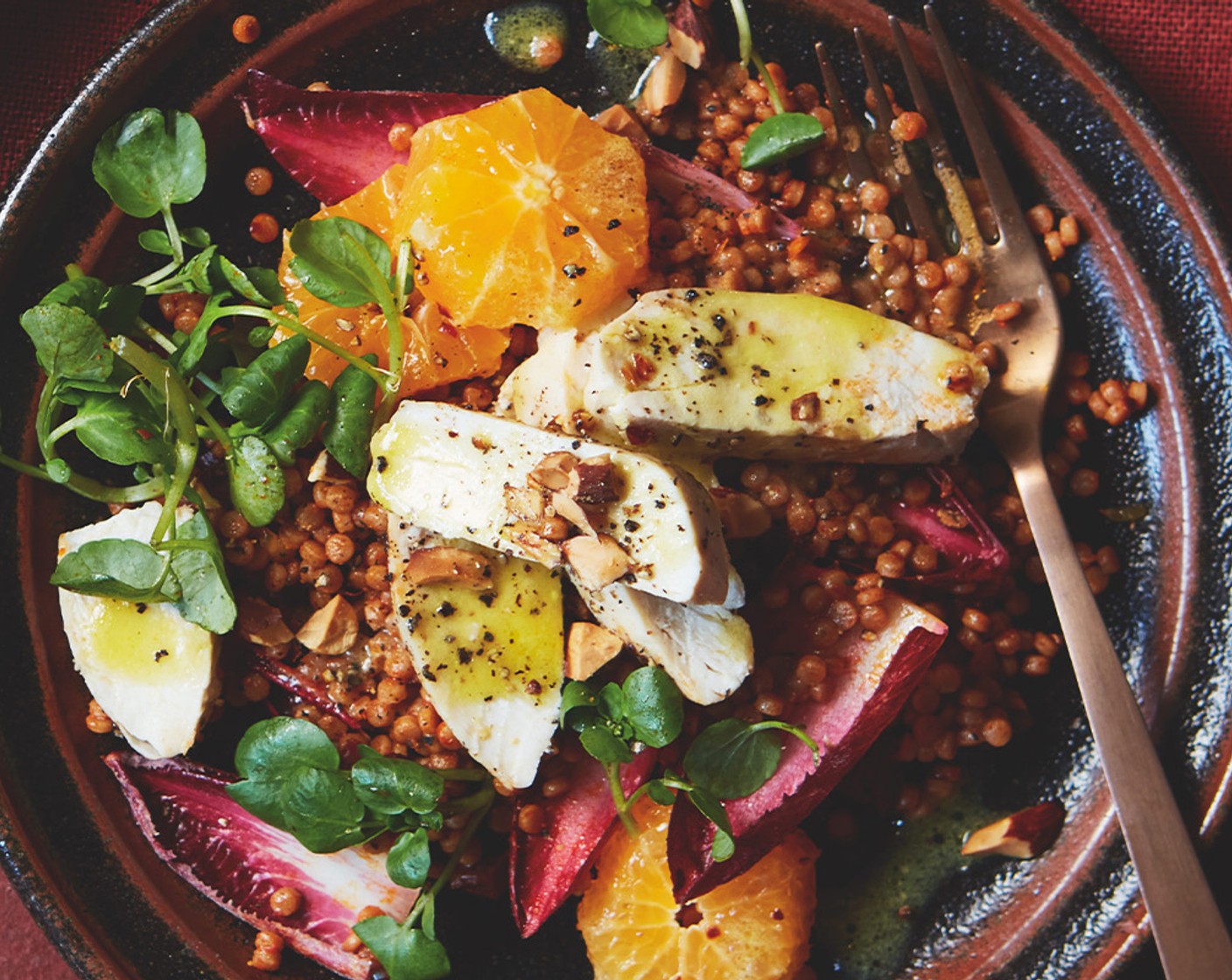 step 5 Toss the couscous with the chicory (2 heads) and watercress (80 g), most of the mint (25 g) and almonds (100 g), and half the orange slices. Unwrap the chicken breasts and carefully stir the juices into the dressing, then thinly slice the chicken. Toss most of the dressing through the salad, then transfer to a serving platter and arrange the remaining orange slices and chicken on top. Scatter with the remaining almonds and mint, drizzle with the remaining dressing and finish with a sprinkling of smoked paprika.