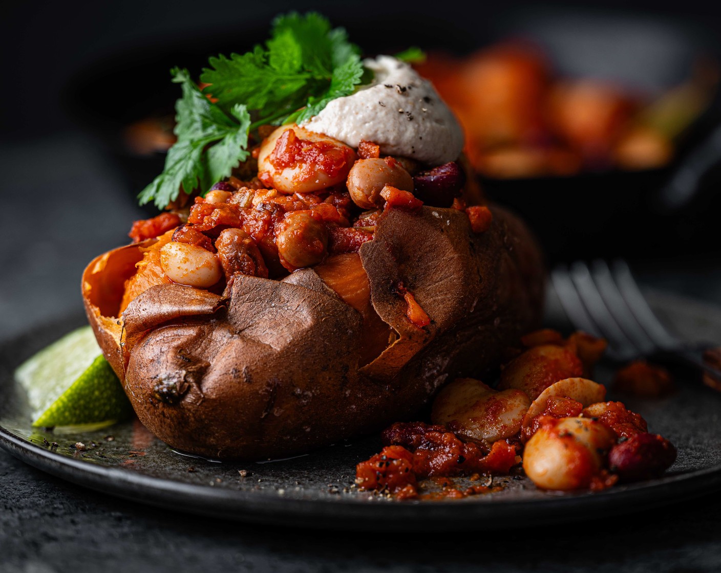 step 5 Serve the sweet potatoes with the smoky beans (discarding the cinnamon sticks and bay leaves), whipped tahini and some fresh coriander (10 g).