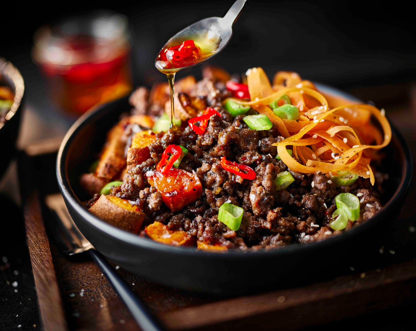 step 5 Serve the beef in bowls with the cooked sweet potatoes, the spring onion and sesame slaw, and a drizzle of hot honey on top.