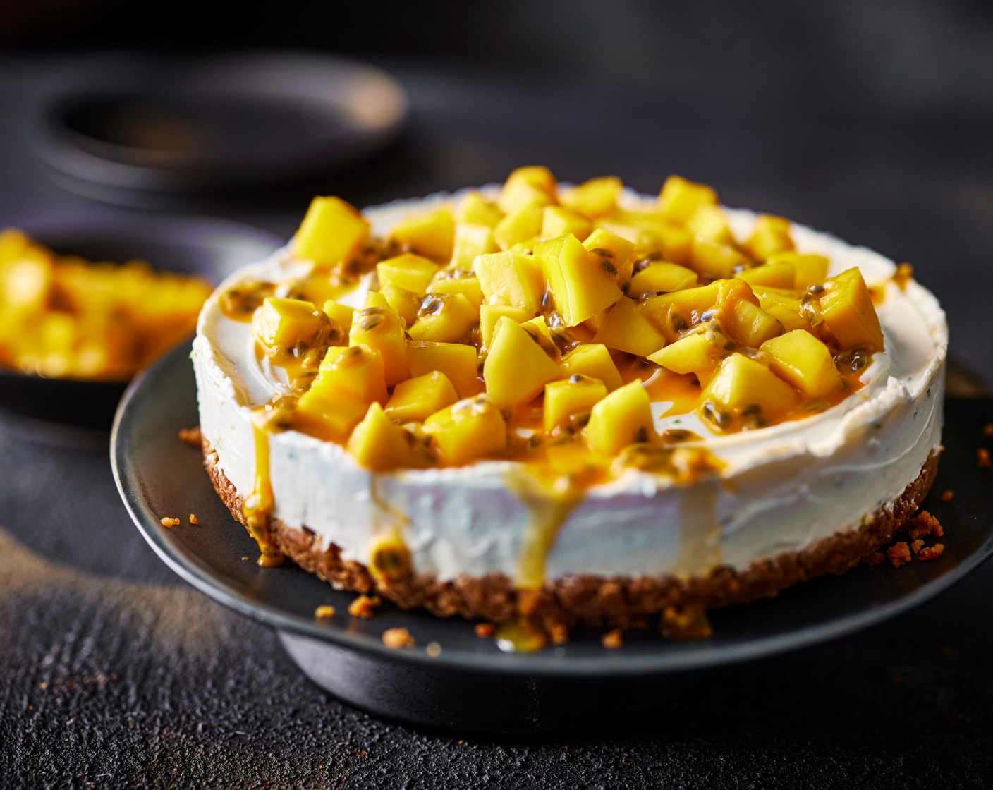 step 5 When you’re ready to serve, finely dice the mango (2) and combine with the lime juice and passion fruit (1). Spoon over the top of the cheesecake and serve with the mango and passion fruit coulis (to taste).