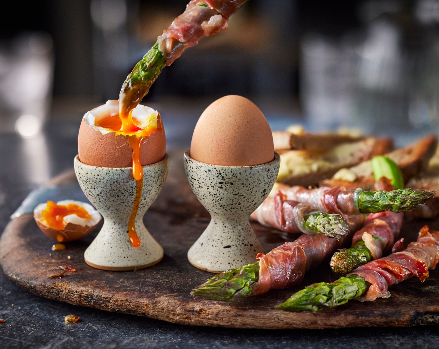 step 6 Pop the eggs into egg cups and put each on a plate. Remove the asparagus from the oven and place alongside the eggs with the buttered toast for dunking.