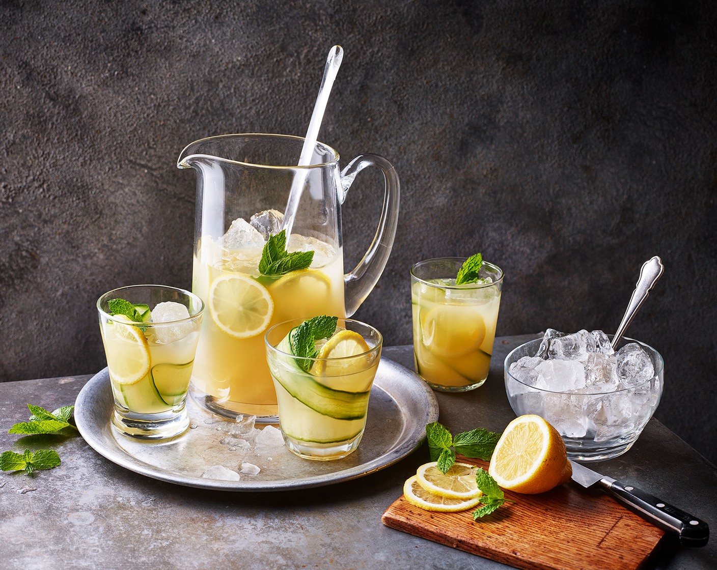 step 4 To serve, artfully place a strip of cucumber (1) around the inside of your serving glass, pour and finish with a slice of lemon (1).