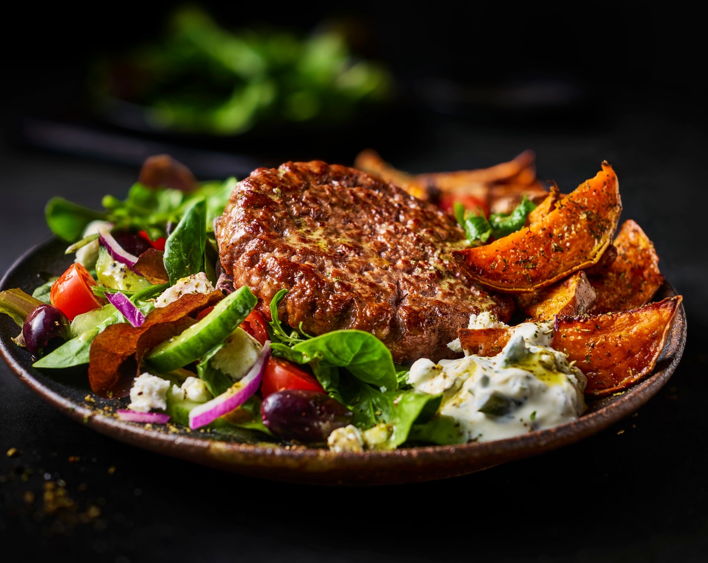 step 4 Serve the grilled burgers in bowls alongside the wedges, salad and tzatziki (2 tbsp).