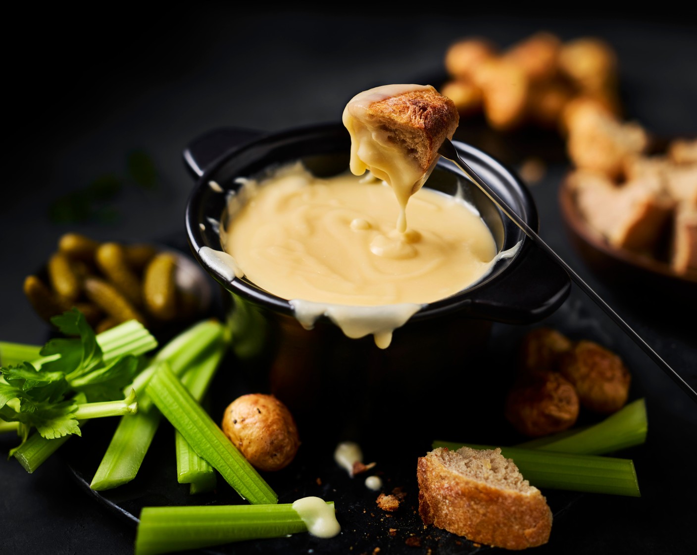 step 5 Serve the fondue (in a fondue pot, if you have it) with the sliced baguette, potatoes, cornichons (12) and celery (6 ribs).