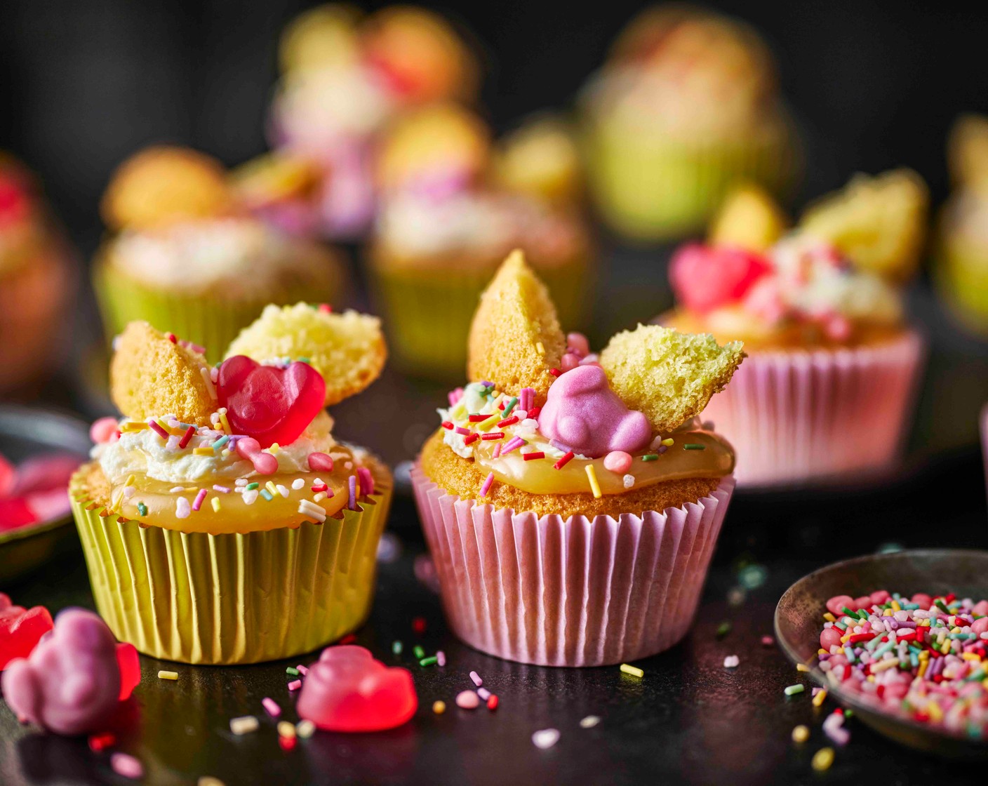 step 6 Fill the gap in the cakes with lemon curd (4 tbsp), then pipe or spoon a swirl of icing on top. Decorate with the cut cake to look like butterfly wings, then press a Percy Piglet (as needed) into each and scatter with Percy Pig sprinkles (as needed).