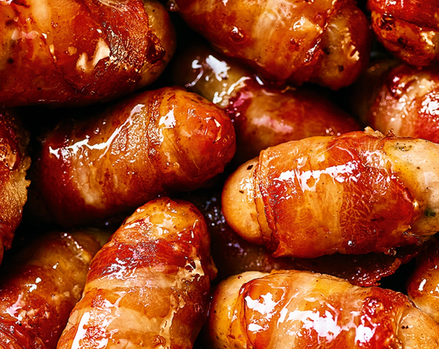 step 2 Remove from the oven and drizzle the hot maple syrup (3 tbsp) over the pigs in blankets. Return to the oven and bake for a further 10 minutes, until sticky and glossy.