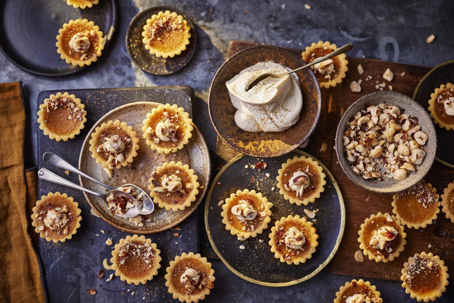 Mini pumpkin spice pies with ginger cream and chopped hazelnuts