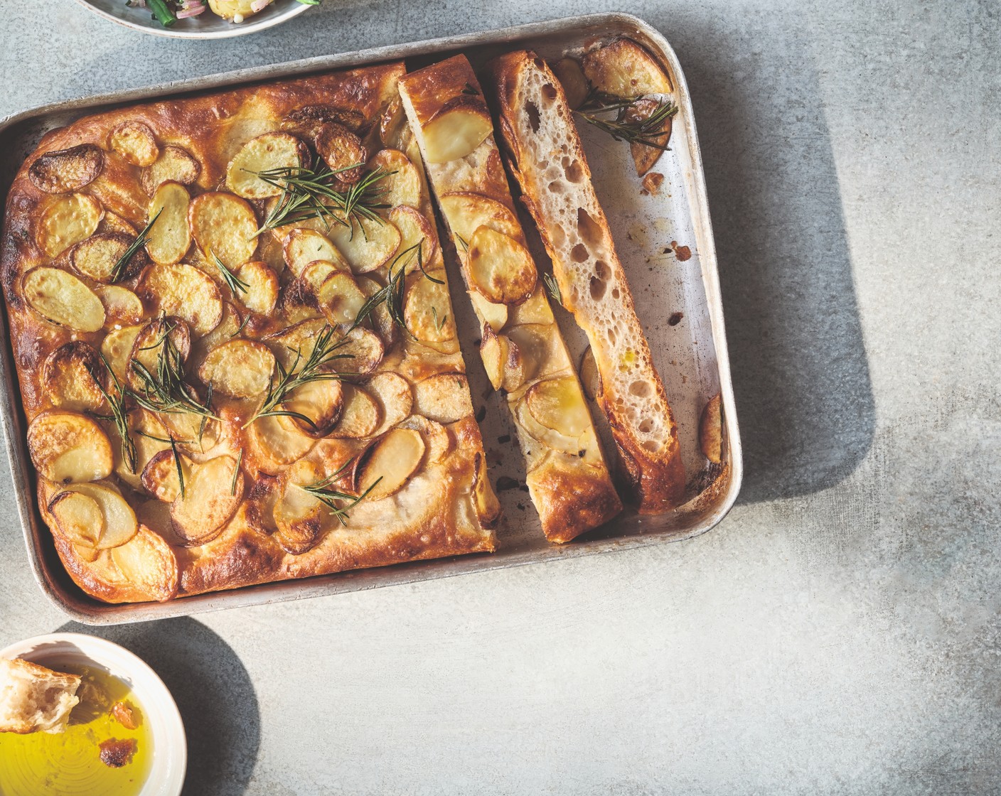 step 5 Bake the focaccia in the oven for 25 minutes, then reduce the temperature to 220°C/200°C fan and bake for 15 minutes, until the potatoes are golden. Scatter over the rosemary for the last 3 minutes of cooking, then serve warm.