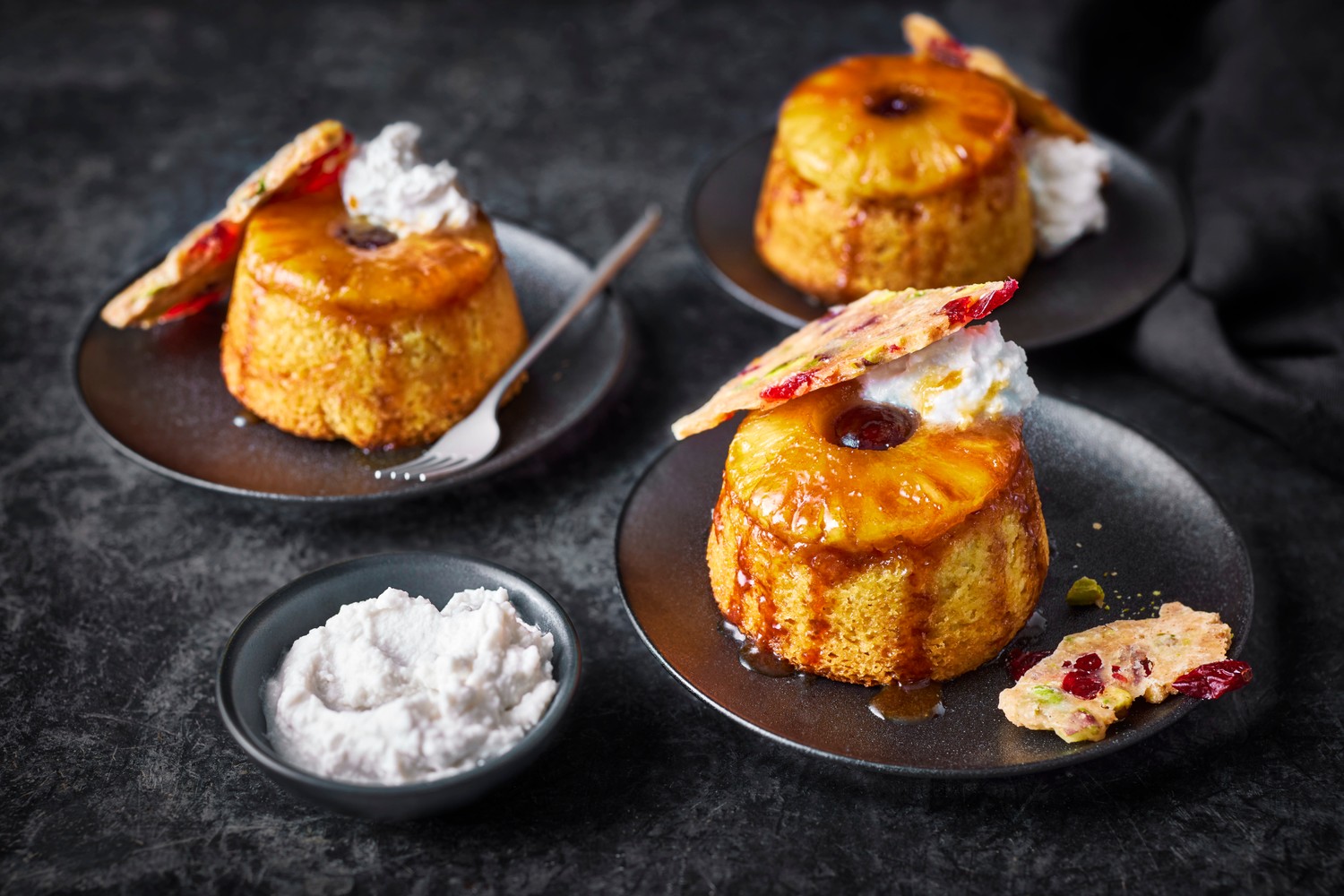 Pineapple upside down cake with coconut cream and fruit and nut brittle