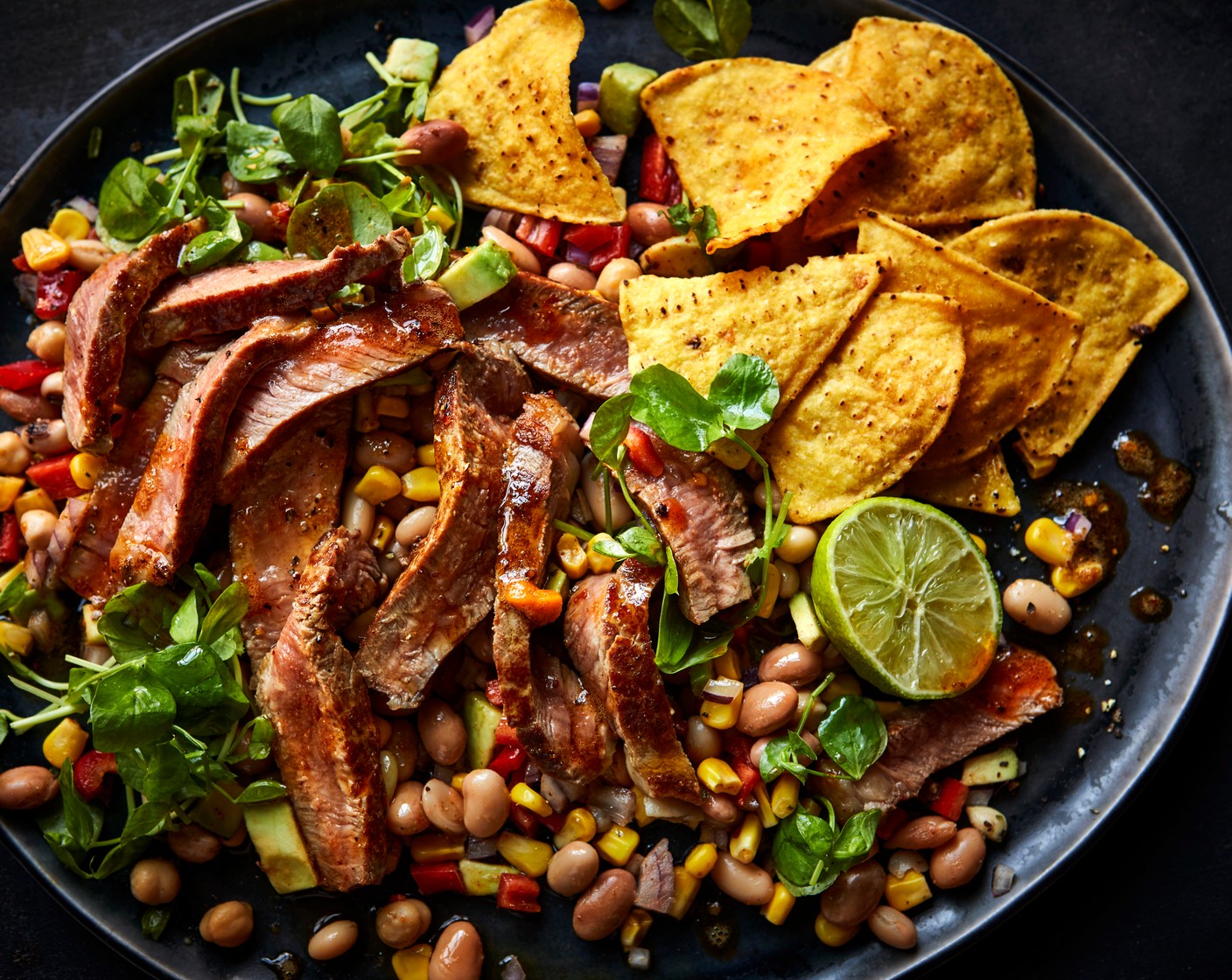step 3 Serve the cowboy caviar with your buttery steak, with a handful of pea shoots (1 handful), and some tortilla chips (1 handful), if you’d like.