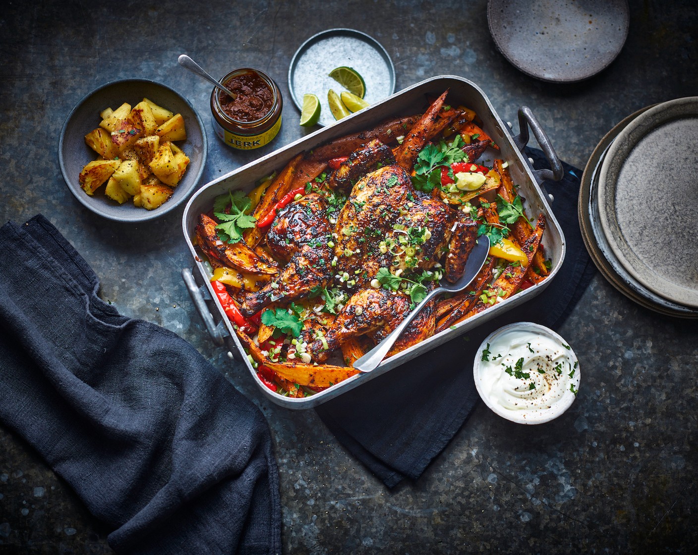 step 6 Serve the traybake with a scattering of spring onions (1 bunch), the chargrilled pineapple and a spoonful of yoghurt (150 g). Finish with a squeeze of lime (1/2) and a scattering of coriander (25 g).