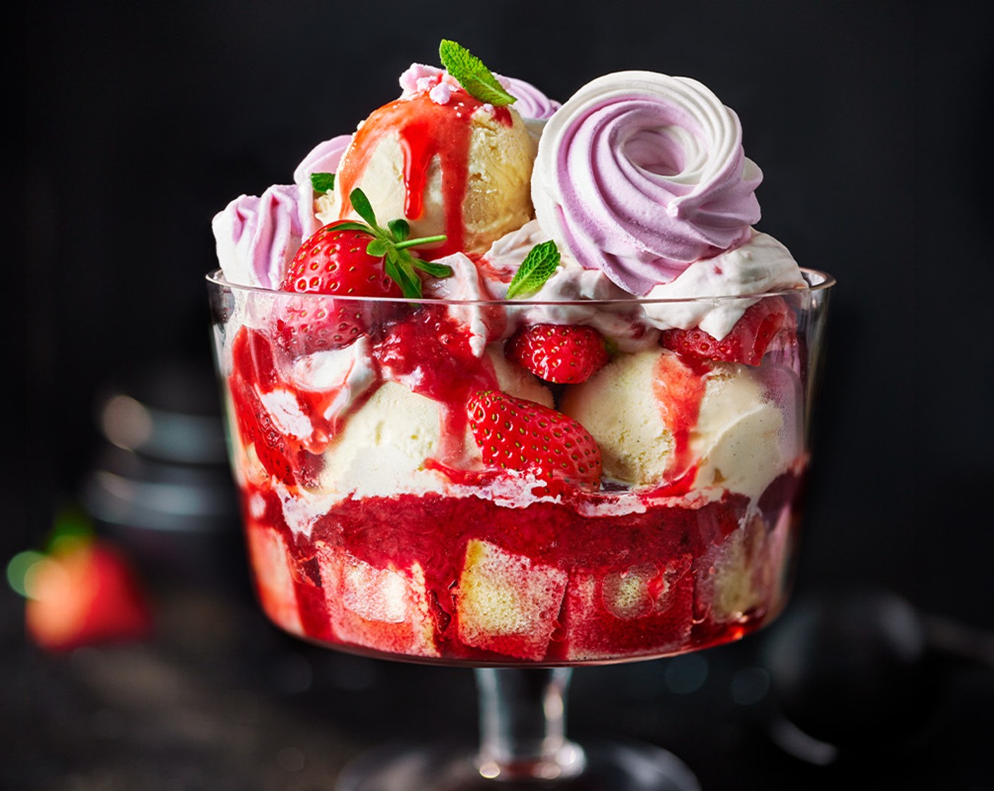 step 5 To assemble, add the Madeira cake chunks to a large trifle dish, pour over 1/3 of the compote, and top with half of the ice cream (500 g). Layer with half of the whipped cream and half of the strawberries. Repeat until you’ve used all the ice cream, cream and berries, finishing by decorating with scoops of ice cream, fresh strawberries, meringue (1 pack) and mint (1 handful).