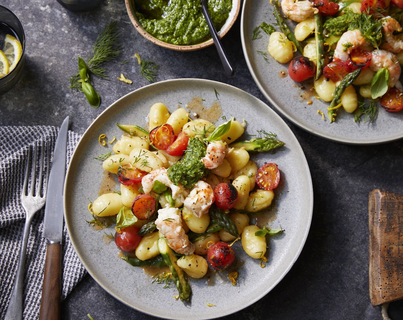 step 12 Plate the gnocchi and top with the asparagus tips, tomatoes and langoustines. Finish with lemon zest (1), dill (8 sprigs), basil (12), white pepper and pesto.