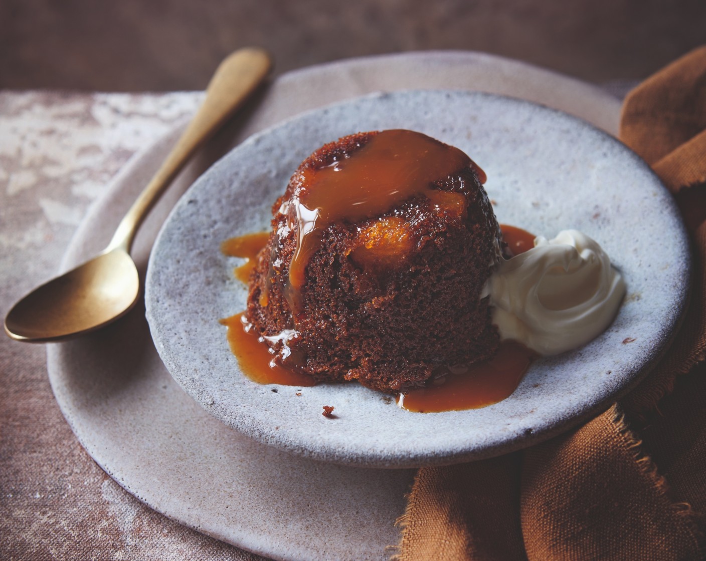 step 5 To remove the puddings from the basins, hold the basin in one hand using a clean tea towel. With your other hand, gently run a butter knife around the edge of the pudding to separate it from the basin, then very carefully tip out onto a serving dish. Pour some of the warm sticky toffee sauce over each, and serve with cream or ice cream.