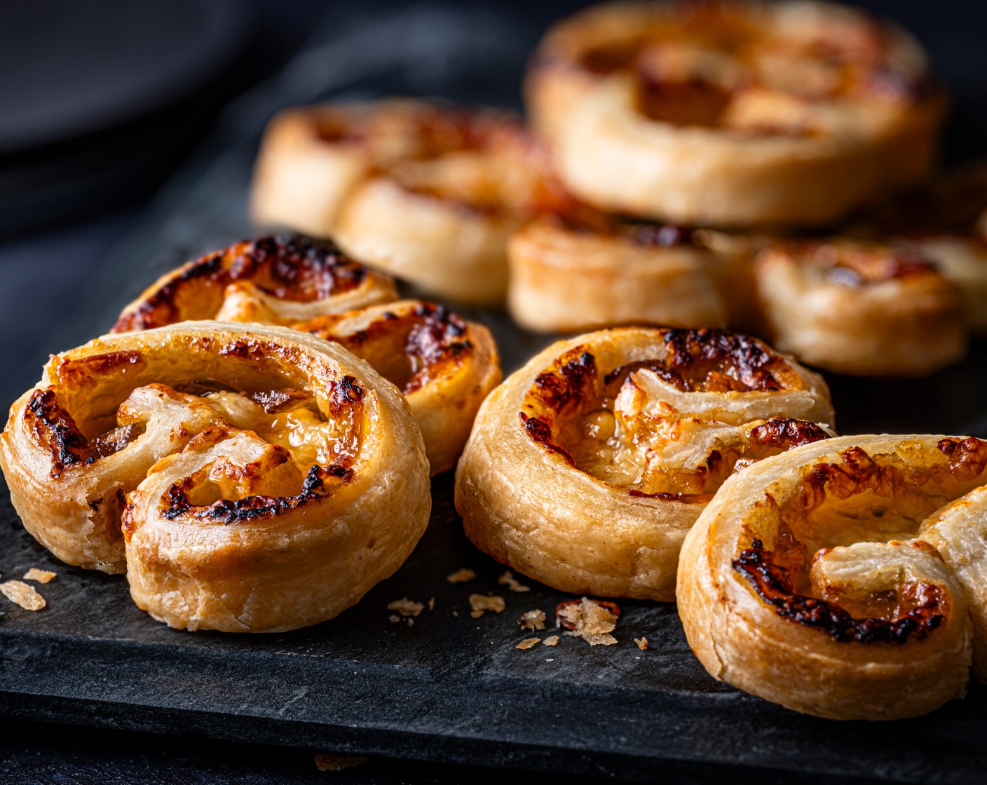 step 5 Using a lightly floured, sharp knife, cut the palmier log into 1cm thick slices. Place onto a greaseproof-lined baking tray, cut side up, leaving space between each to allow them to puff up, and bake for 12-15 minutes, until the pastry is crisp and golden.