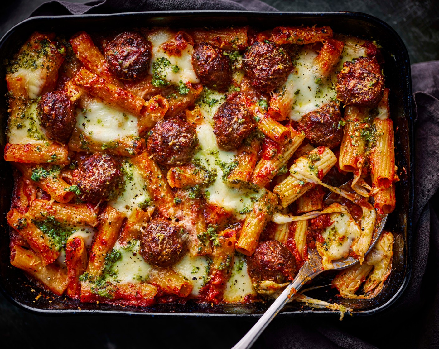 step 5 Top with the mozzarella balls (1 tub) and grated parmesan (25 g). Bake for 25 minutes, until golden brown.