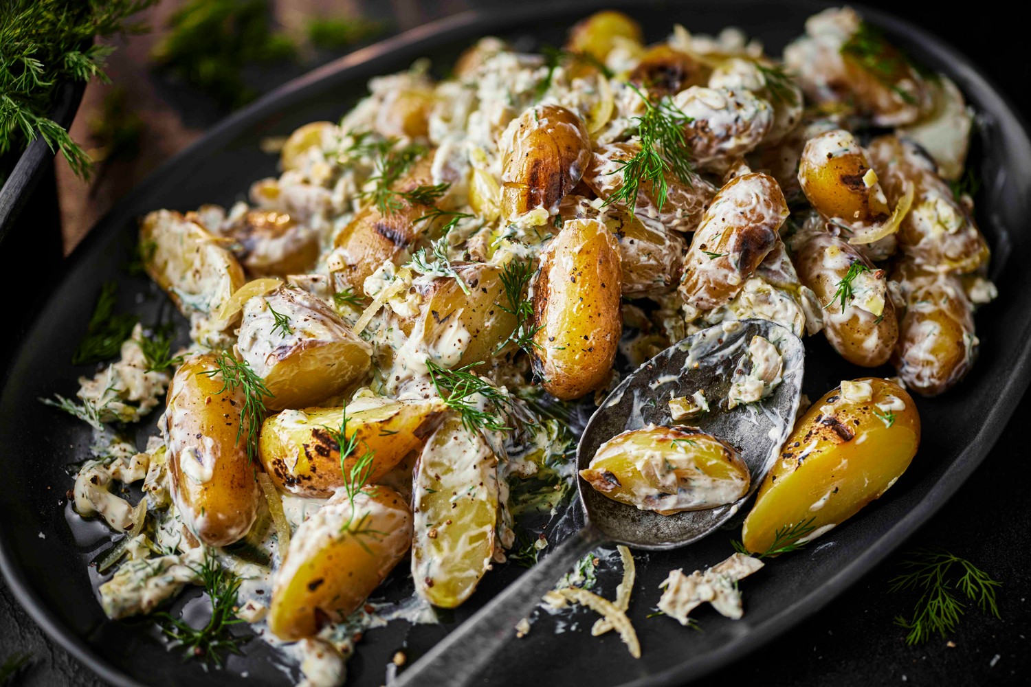 Barbecue Jersey royal potatoes with preserved lemon, green olive and dill dressing