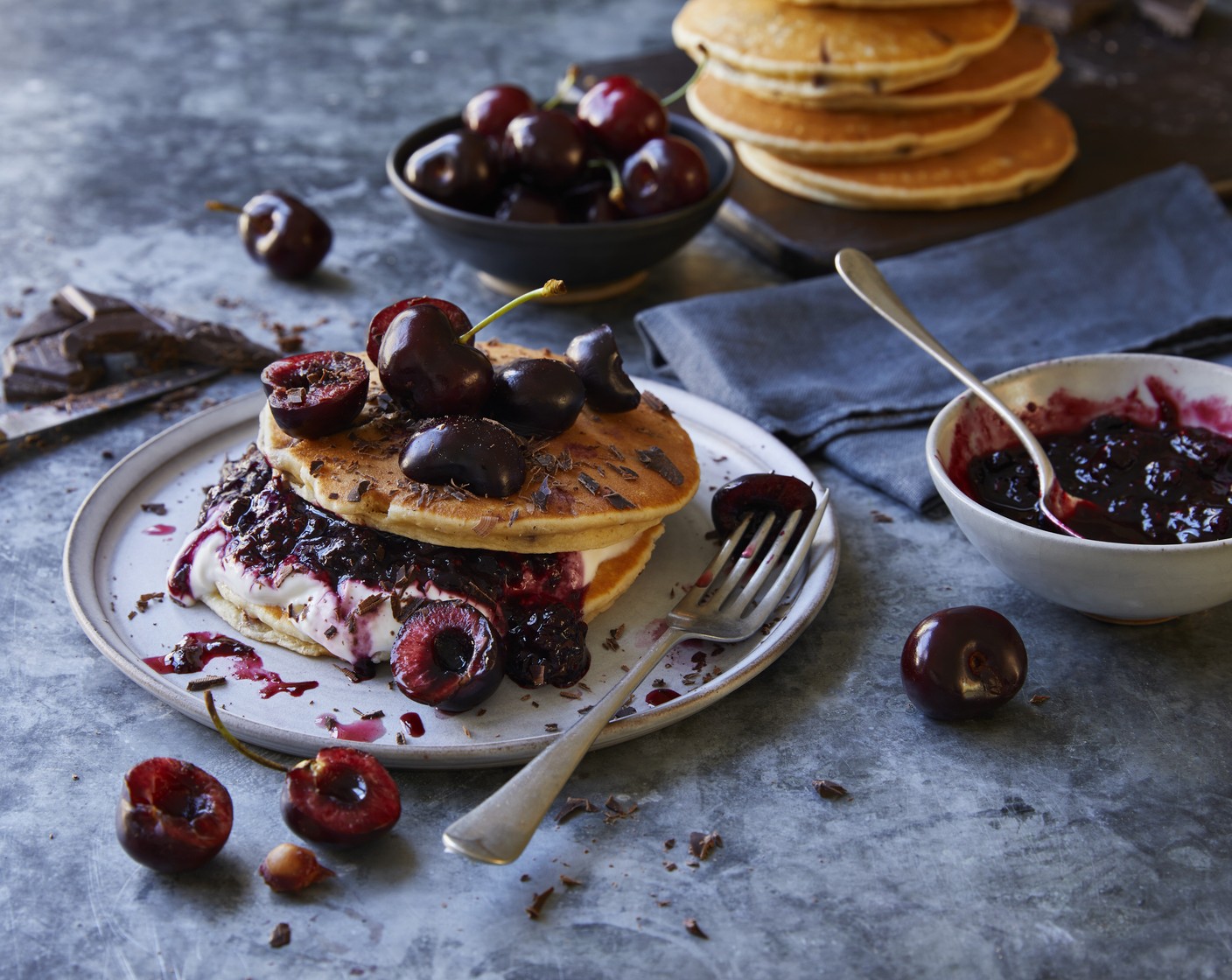 step 3 To serve, scatter ¼ of the cherries (1 punnet) over each plate and generously grate over some of the Belgian chocolate (40 g). Serve any remaining yogurt alongside, if you like.