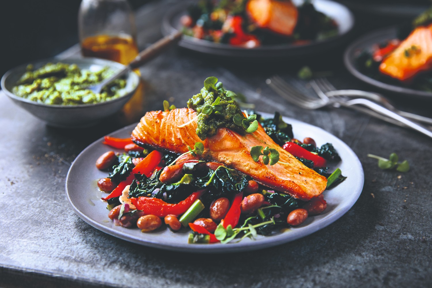 Pan fried salmon with borlotti bean and cavolo nero stew and walnut pesto