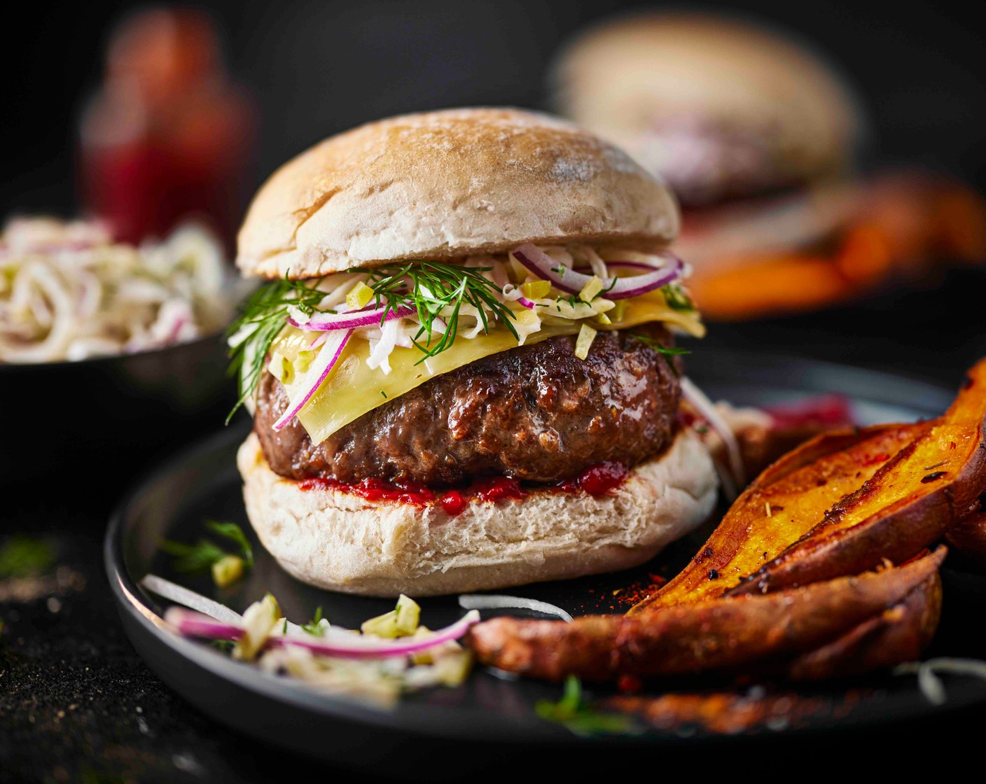 step 7 To assemble your burgers, add the burgers to the buns and top with a spoonful of slaw. Serve with the sweet potato wedges, ketchup (to taste) for dipping, and a little extra slaw, if you like.