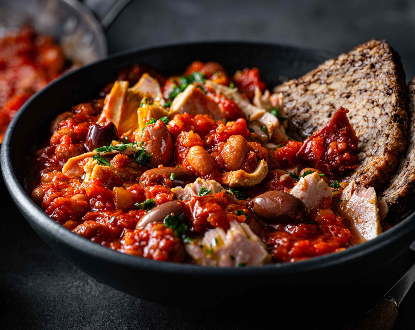 step 4 Spoon the tuna stew into bowls and drizzle over the parsley dressing. Serve with our super seeded oaty bread (4 slices).
