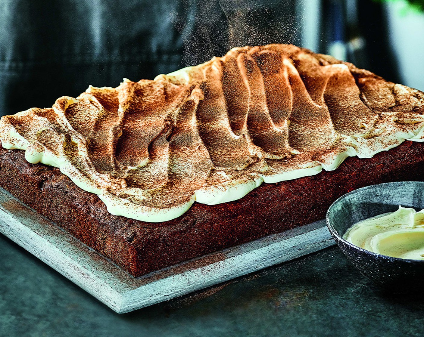 step 8 Once the cake is cool, spread the frosting on top. Mix together the mixed spice (1/4 tsp) and cinnamon (1/4 tsp) in a small bowl and sprinkle this over the cake. Cut into squares.