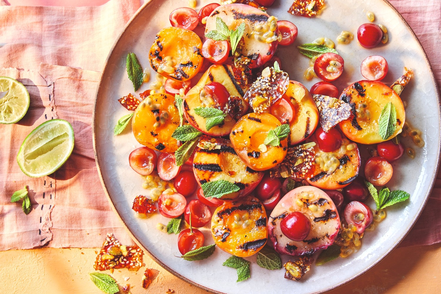 Charred stone fruit salad with pistachio and sesame brittle