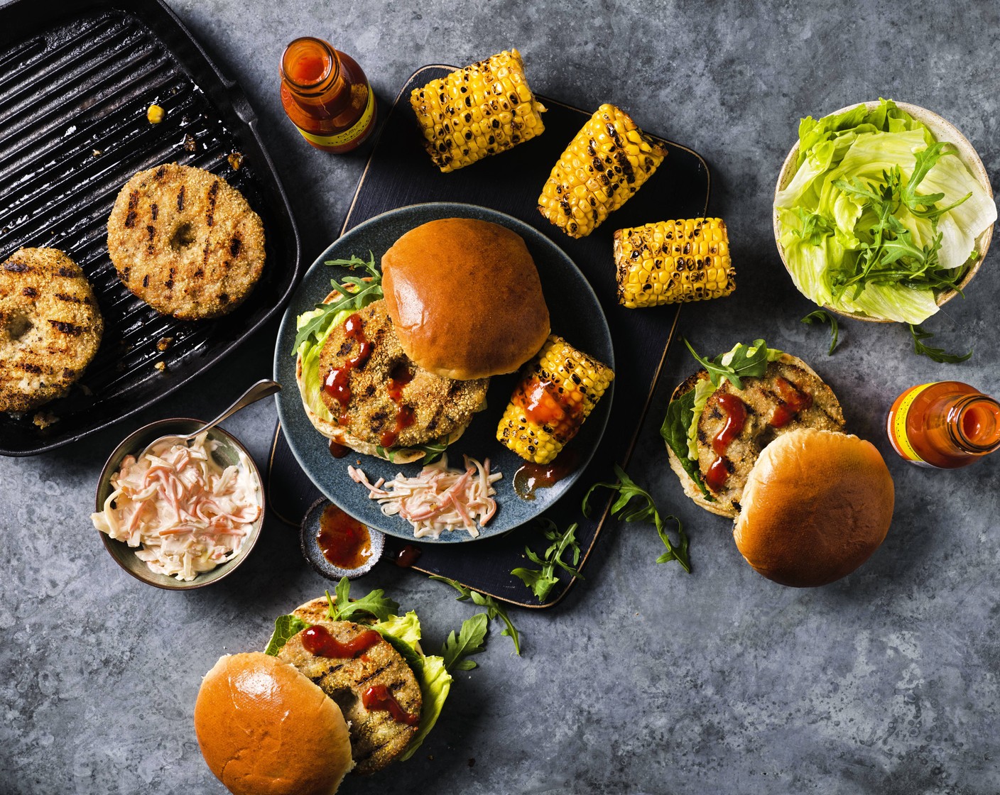 step 5 Drizzle the sweetcorn with the M&S buffalo sauce (4 tbsp) and serve alongside the burgers with a spoonful of M&S deli style coleslaw (300 g).