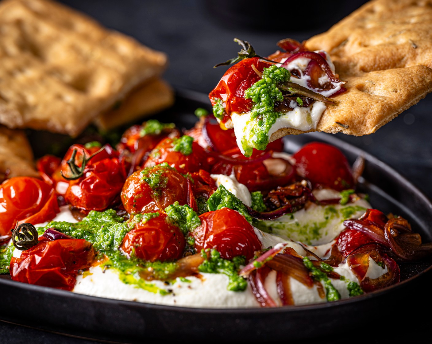 step 6 Top the burrata with the tomato mix. Finish with a drizzle of pesto (to taste) and season. Use the focaccia (1 pack) to load up with dip.