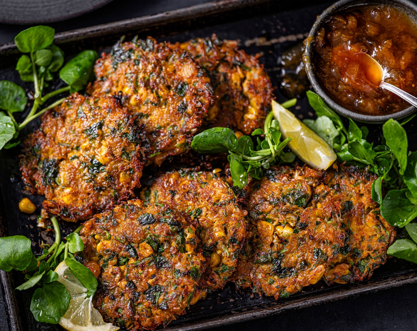 step 5 Toss the watercress (80 g) in the lemon oil (1/2 tbsp). Serve the fritters with the lemony dressed watercress and peach relish (4 tbsp) on the side.
