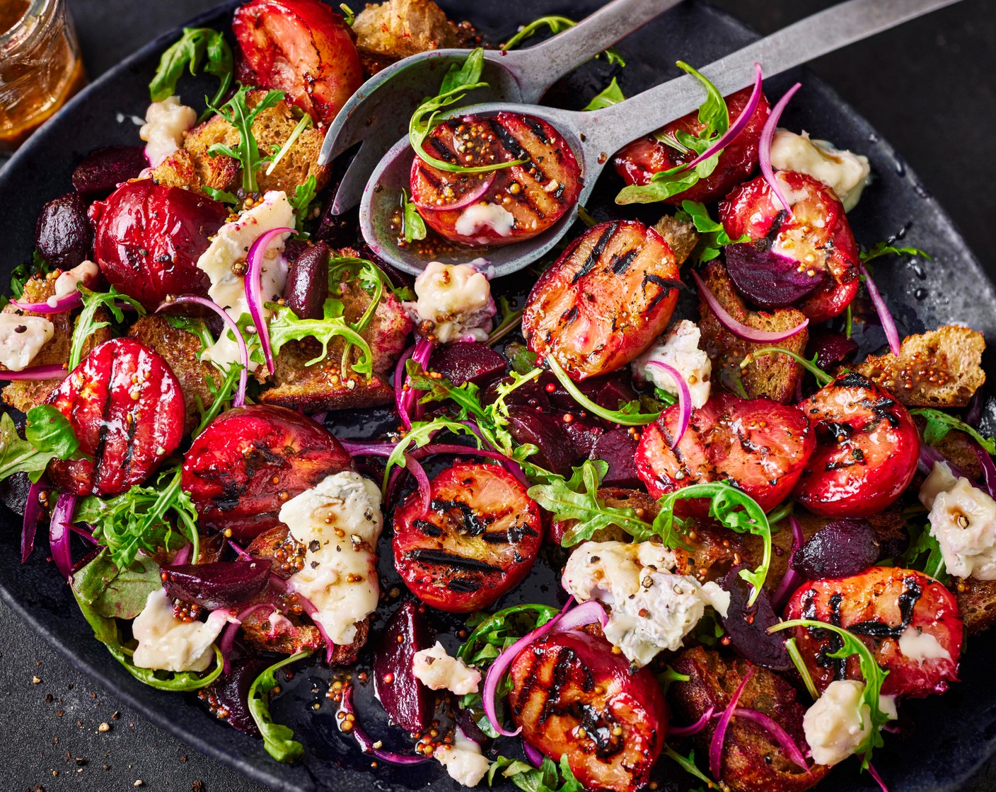 step 6 When you’re ready to assemble, toss together the rocket (40 g), croutons, beetroot (200 g) and red onion with most of the dressing in a large bowl. Tumble onto a big platter, then arrange the plums on top and tear over the gorgonzola (75 g). Spoon over the remaining dressing.