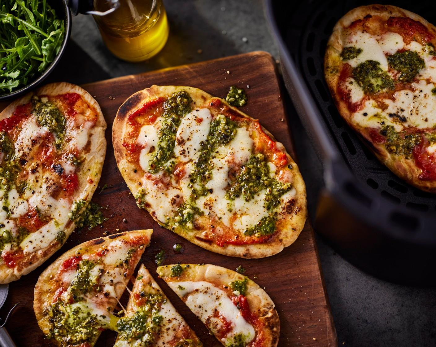 step 2 Spoon 2 tsp green pesto (8 tsp) over each then air fry at 200°C for 4-6 minutes, until the pittas are golden brown and the cheese has melted.
