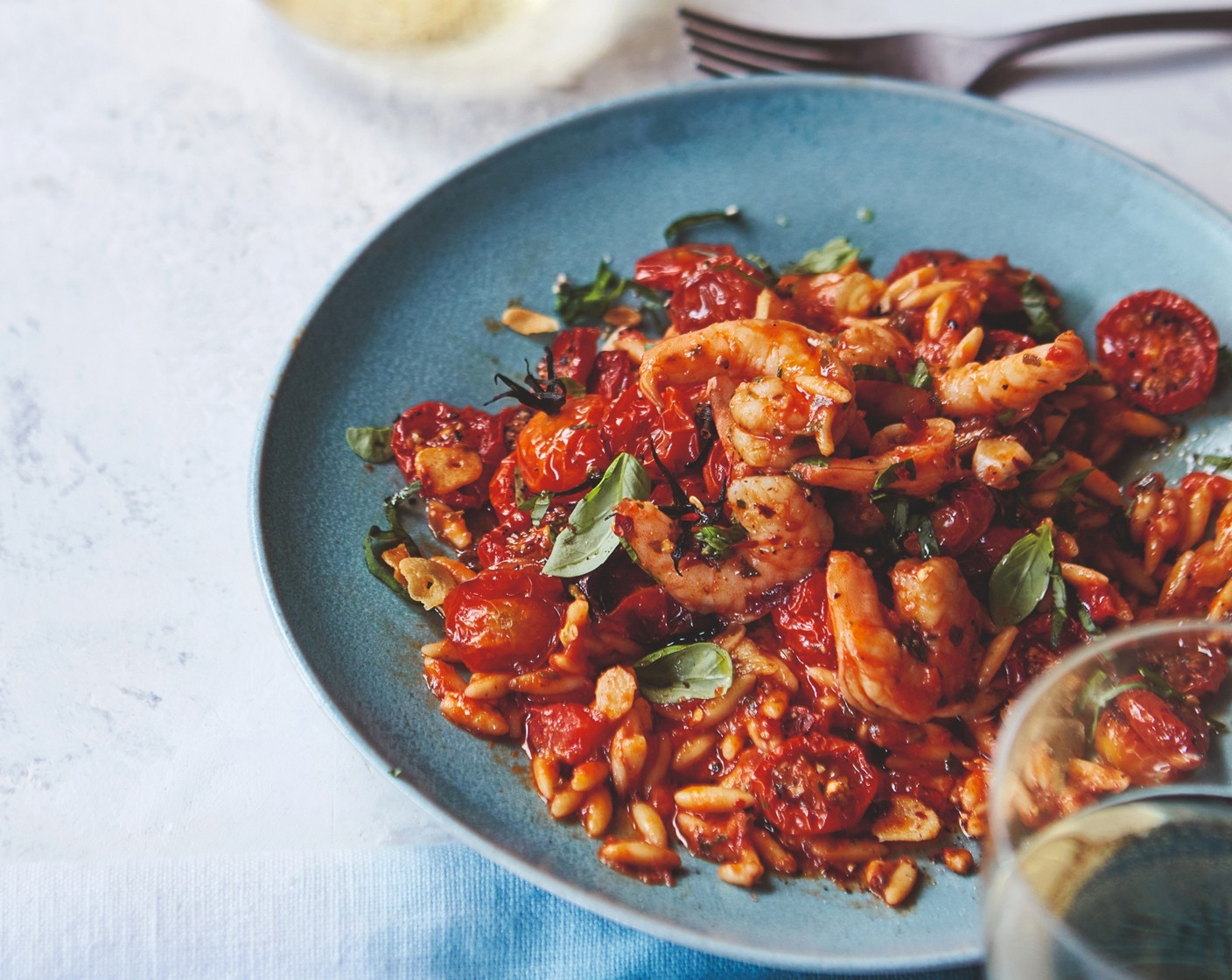 step 4 Stir the prawns (1 pack) and half the basil (1 bunch) into the orzo, followed by the roasted tomatoes. Serve with the remaining fresh basil scattered on top, along with an extra drizzle of olive oil.