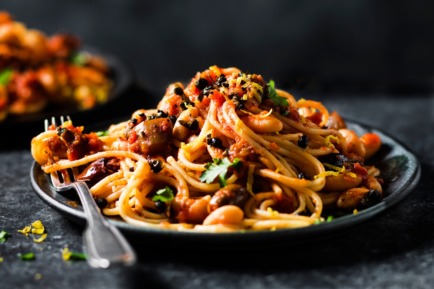 Aubergine pasta with capers, olives and cannellini beans
