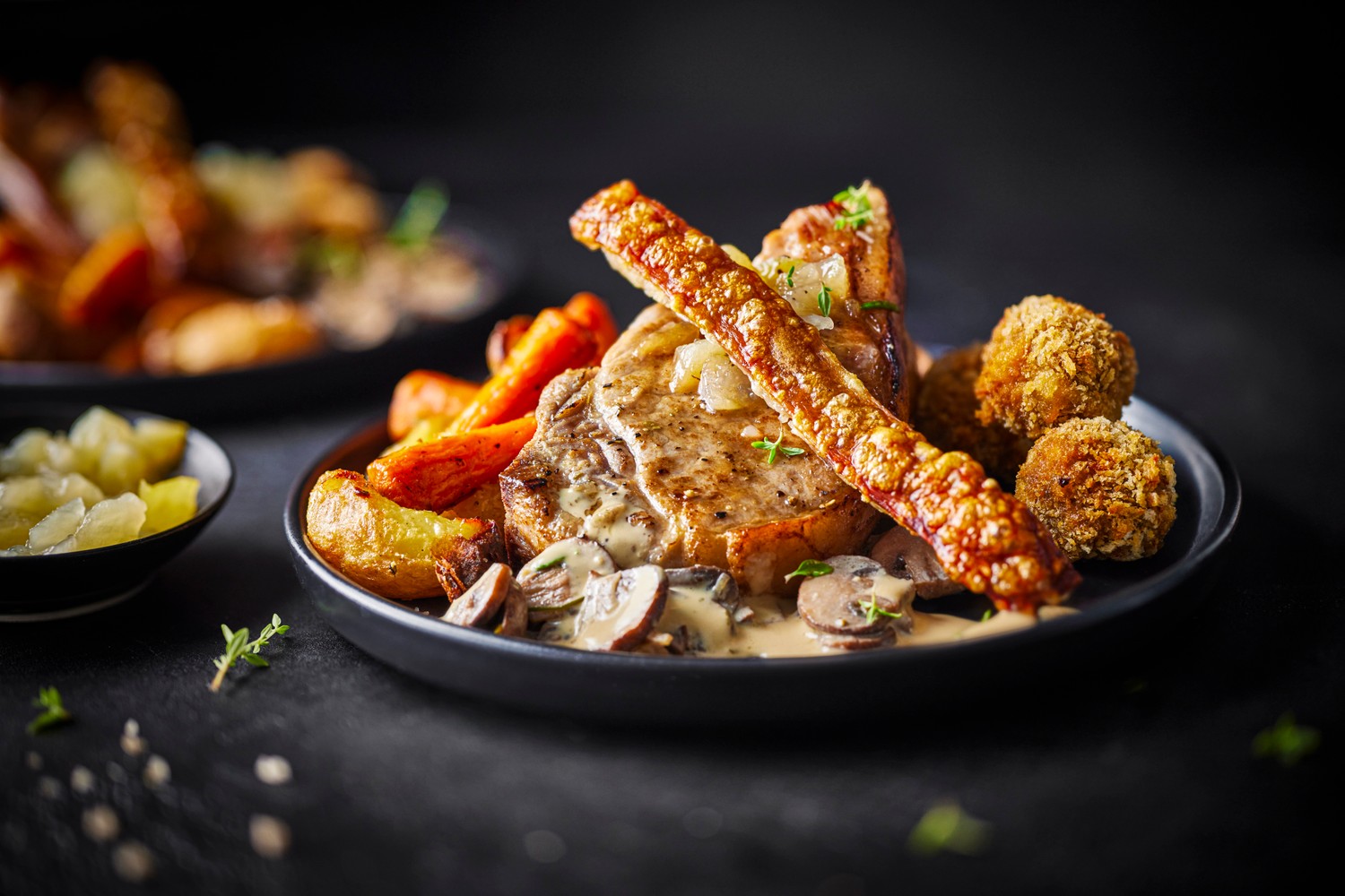 Pan-roasted pork chops, crackling and sausage bon bons