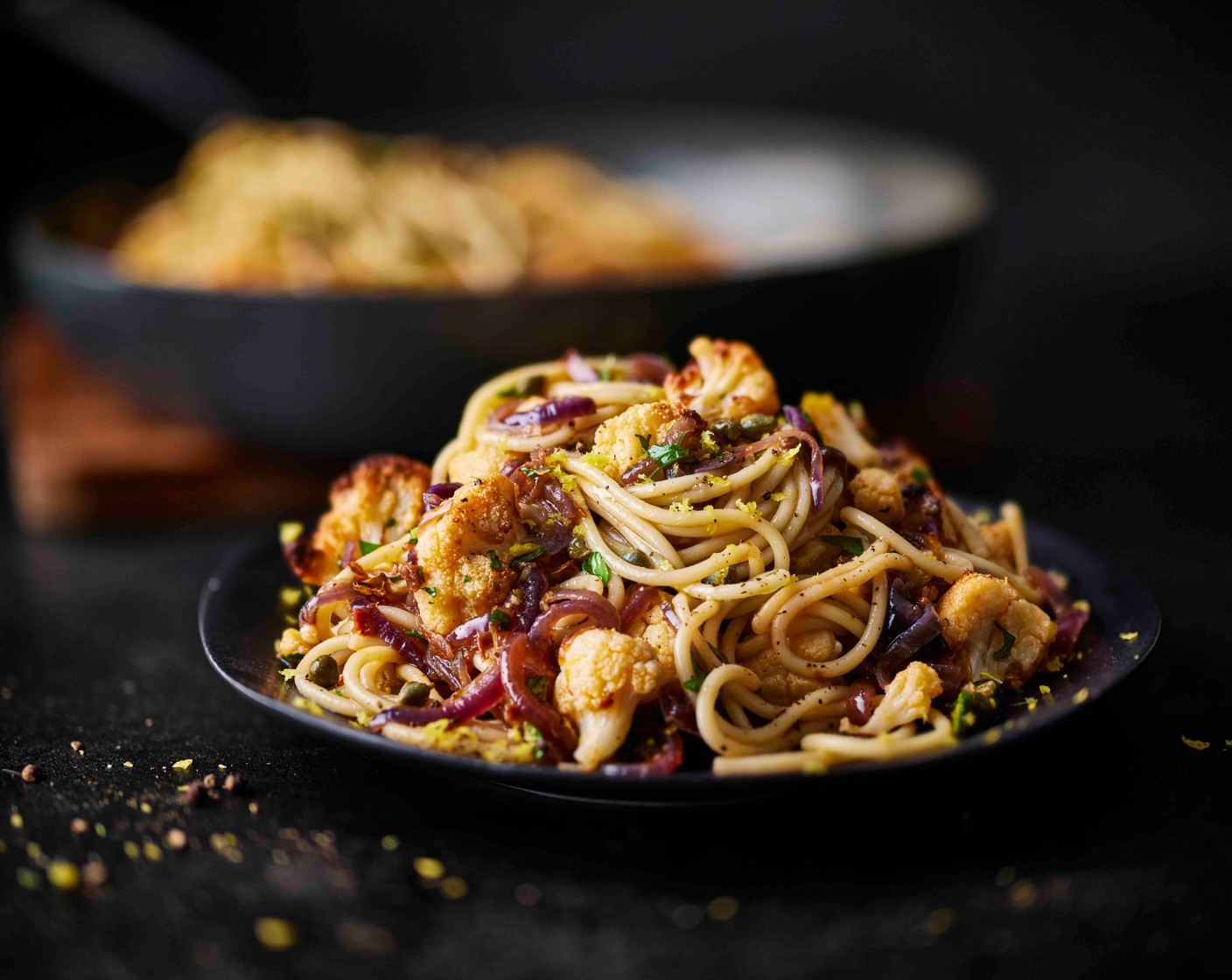 step 6 Drain the spaghetti, reserving a cup of the pasta cooking water, and add to the pan with the onions. Stir through the roasted cauliflower, capers (2 tbsp), parsley (15 g), and lemon juice and zest (1). Add a splash of pasta cooking water and toss together. Finish with a drizzle of olive oil.