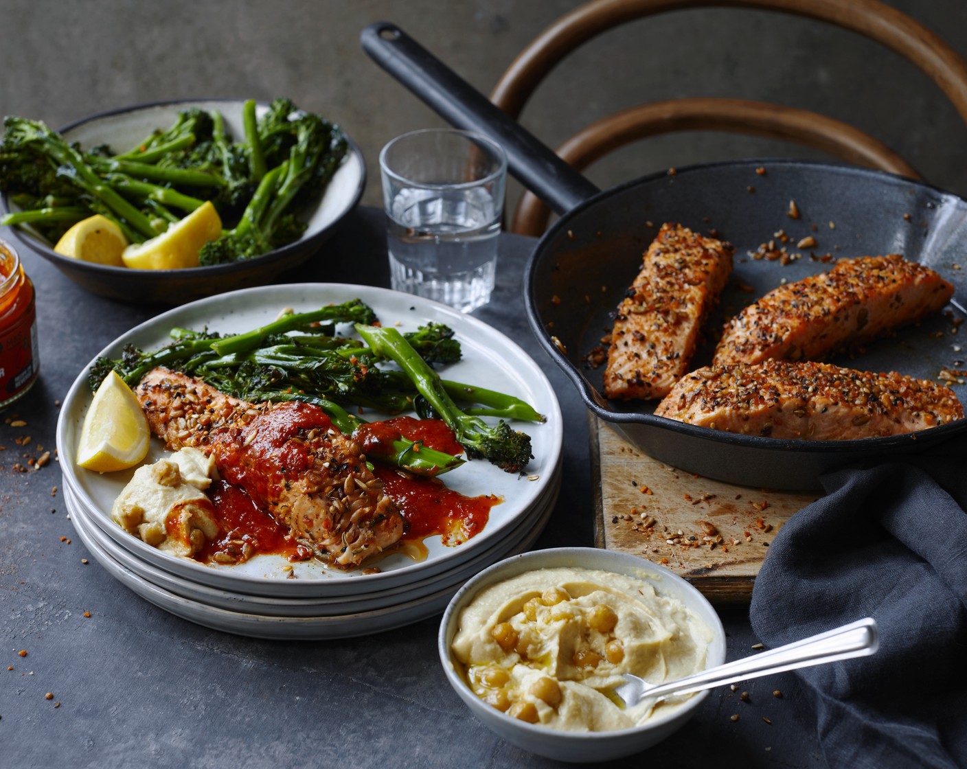 step 5 Divide the broccoli between four plates, place the salmon alongside, with a dollop of the houmous (1 pot) and drizzle over the red pepper paste mix. Cut the rest of the lemon (1/2) into wedges and serve.
