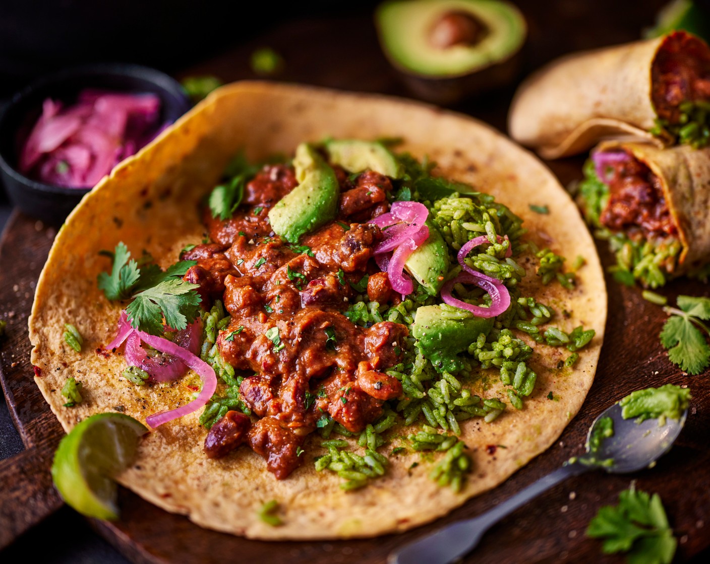 step 8 Assemble the burritos with the rice, beans, avocado, a scattering of coriander and a handful of pickled red onions (1 tbsp).