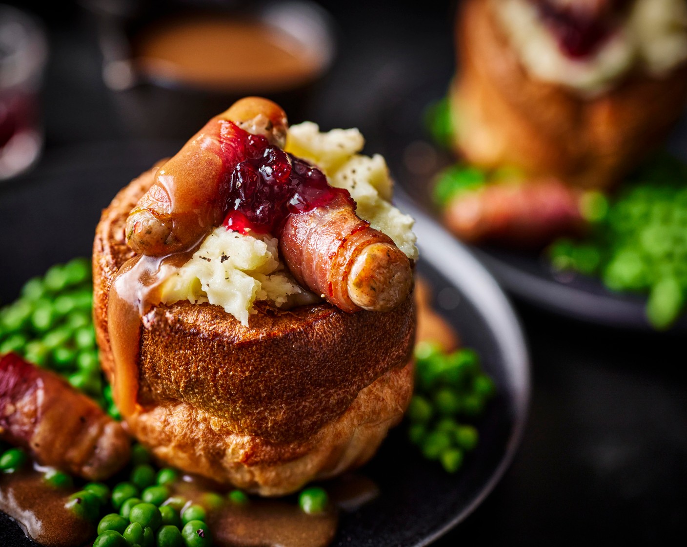 step 6 Stuff the Yorkshire puddings with mashed potato and stud with a dollop of cranberry sauce (4 tbsp). Top with the pigs in blankets and pour over the gravy. Serve with peas.