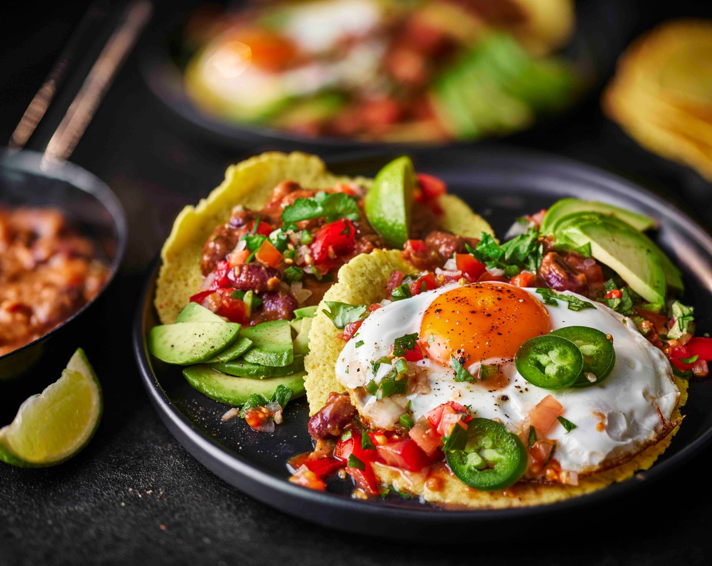step 6 Serve the warm tortillas topped with the bean mix, the eggs, the remaining salsa and the avocado. Finish with some more fresh coriander.