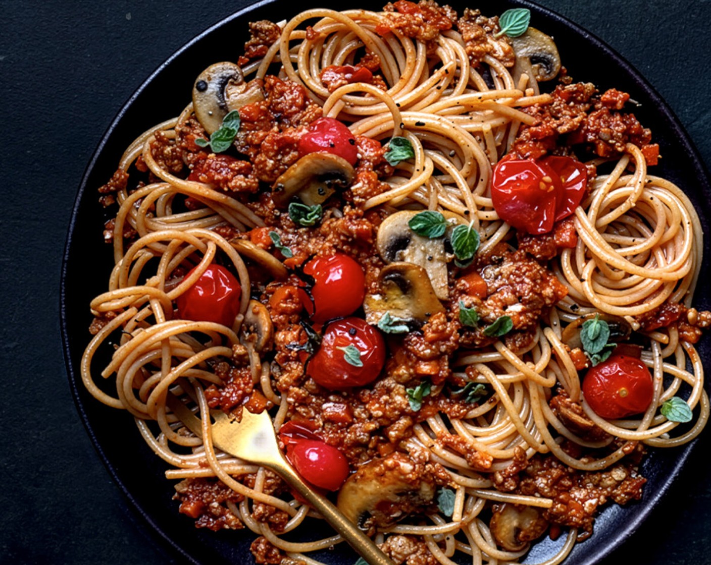 step 5 Drain the pasta and toss into the sauce, then stir in the roasted mushrooms and tomatoes. Serve with some fresh oregano (5 g) on top.