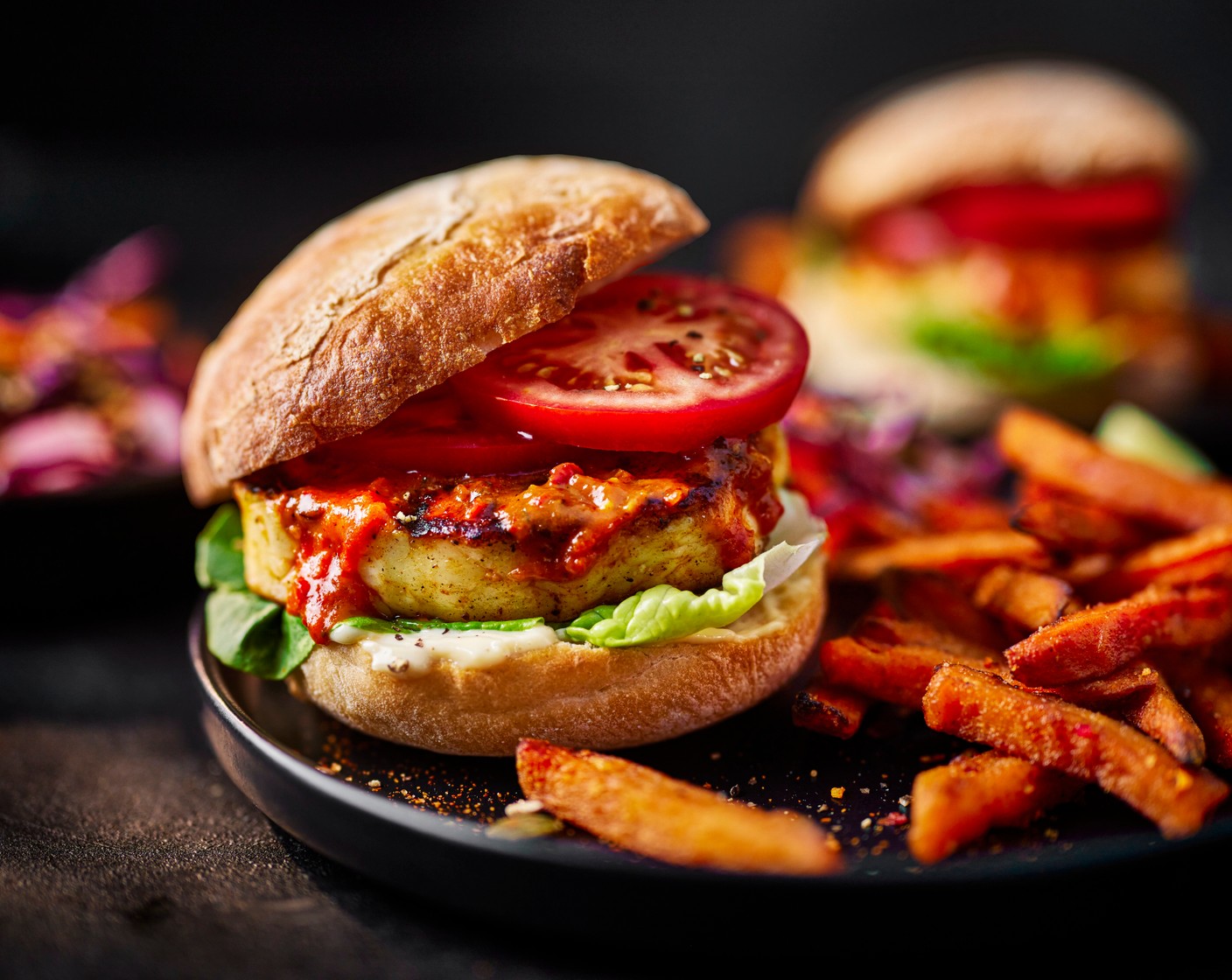 step 6 Toss the cooked sweet potato fries in the piri piri seasoning (1 tbsp). Halve the ciabatta rolls and spread mayo (4 tbsp) onto the bottom, if using. Top with the lettuce (1 head), halloumi burger and tomato (2), then place the burger lid on top. Serve with your sweet potato fries and rainbow slaw.