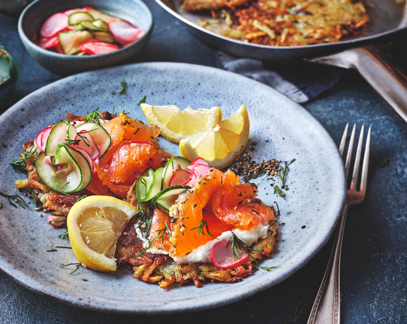 step 4 Top each latke with the horseradish cream (1 pot), smoked salmon (2 packs) and pickles. Garnish with dill (1 handful) and black pepper and serve each portion with a wedge of lemon (1).