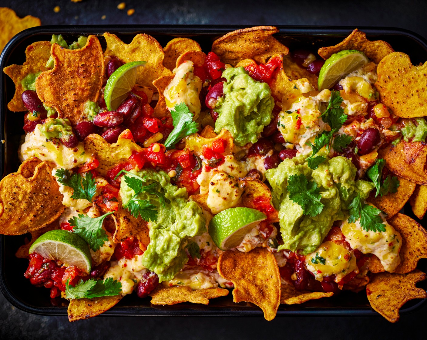 step 4 Serve with a spoonful of guacamole (1 tub), the lime wedges (2) and some fresh coriander (15 g) on top.