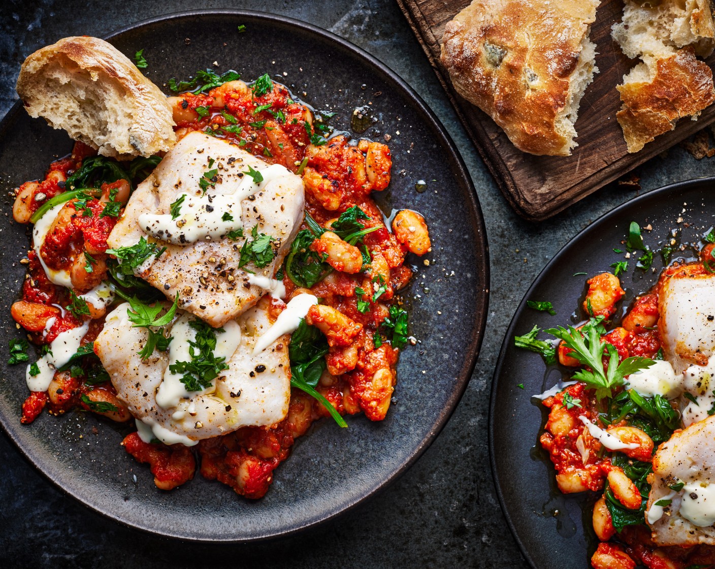 step 6 Serve the fish and beans with a dollop of aioli (4 tsp) on top and the warm, crusty bread on the side.