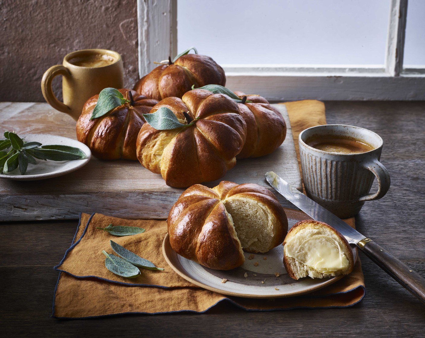 step 9 Allow the buns to cool for five minutes, then carefully remove the twine with scissors. Place an almond or cinnamon stick into the top of each bun to resemble a pumpkin stalk.